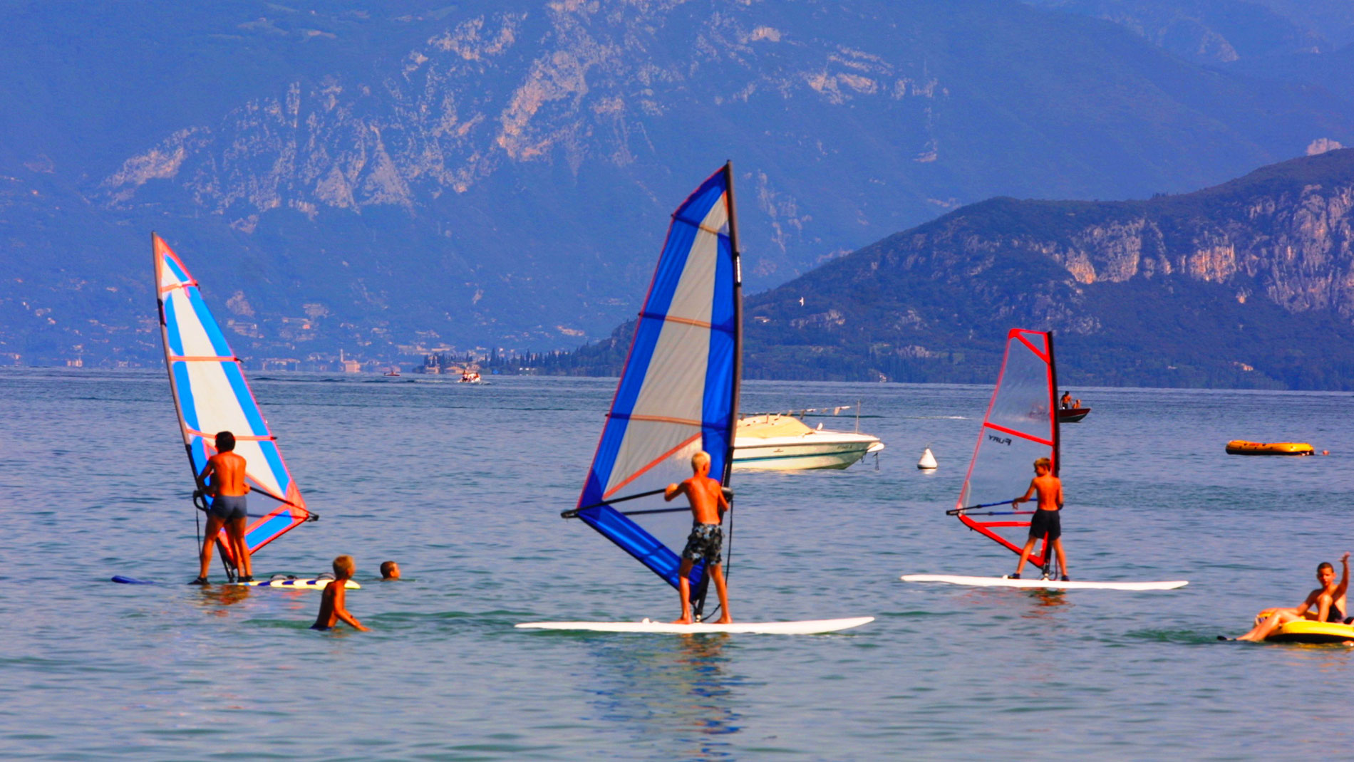 people windsurfing in the lake