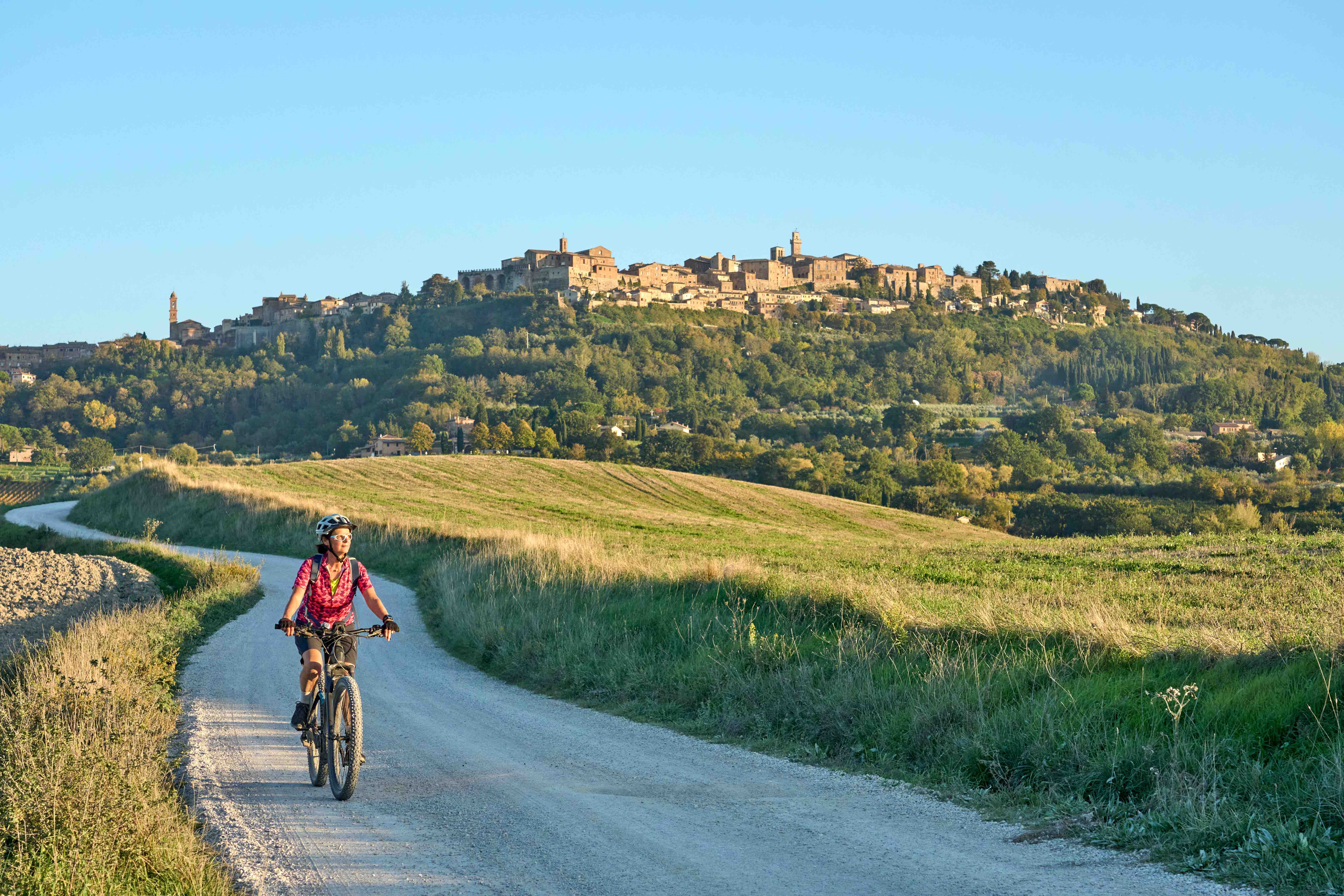 Weinstraße im Chianti-Gebiet mit Radfahrern und sanften Hügeln